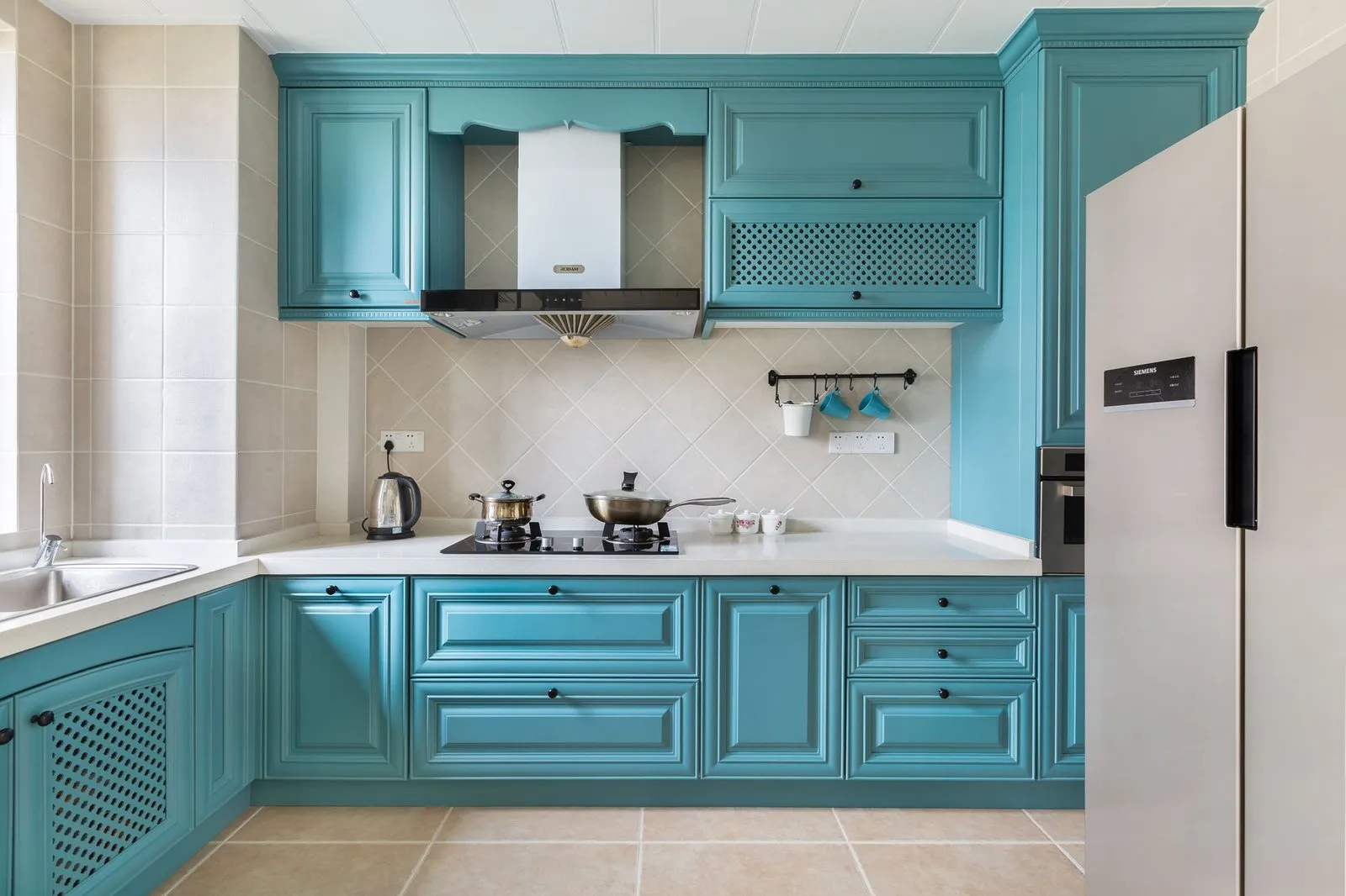 Sage green kitchen cabinets with warm wood accents by Vamaylo