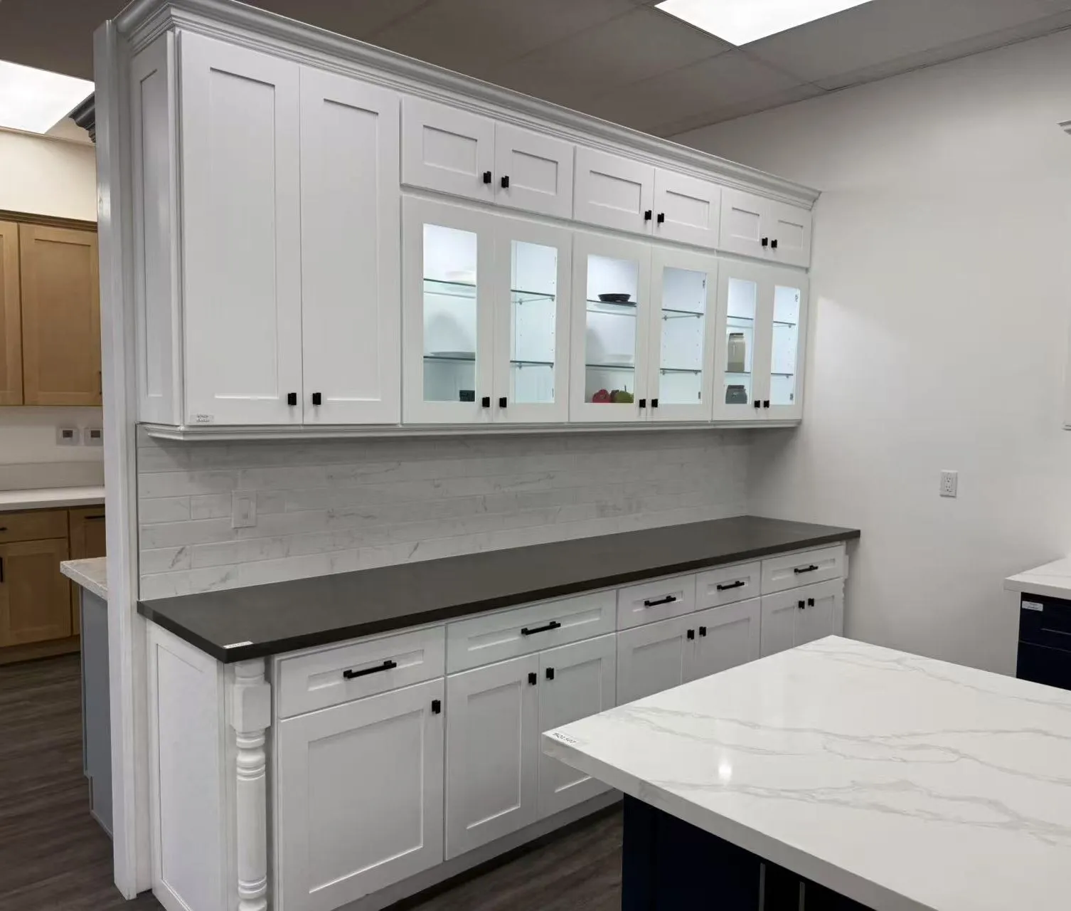 A Vamaylo shaker kitchen installation in progress, white cabinetry with a marble island